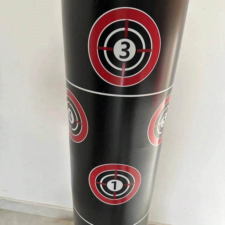 Gros plan sur la partie haute d'un punching ball gonflable noir avec des cibles rouges et blanches numérotées 1, 3 et 4